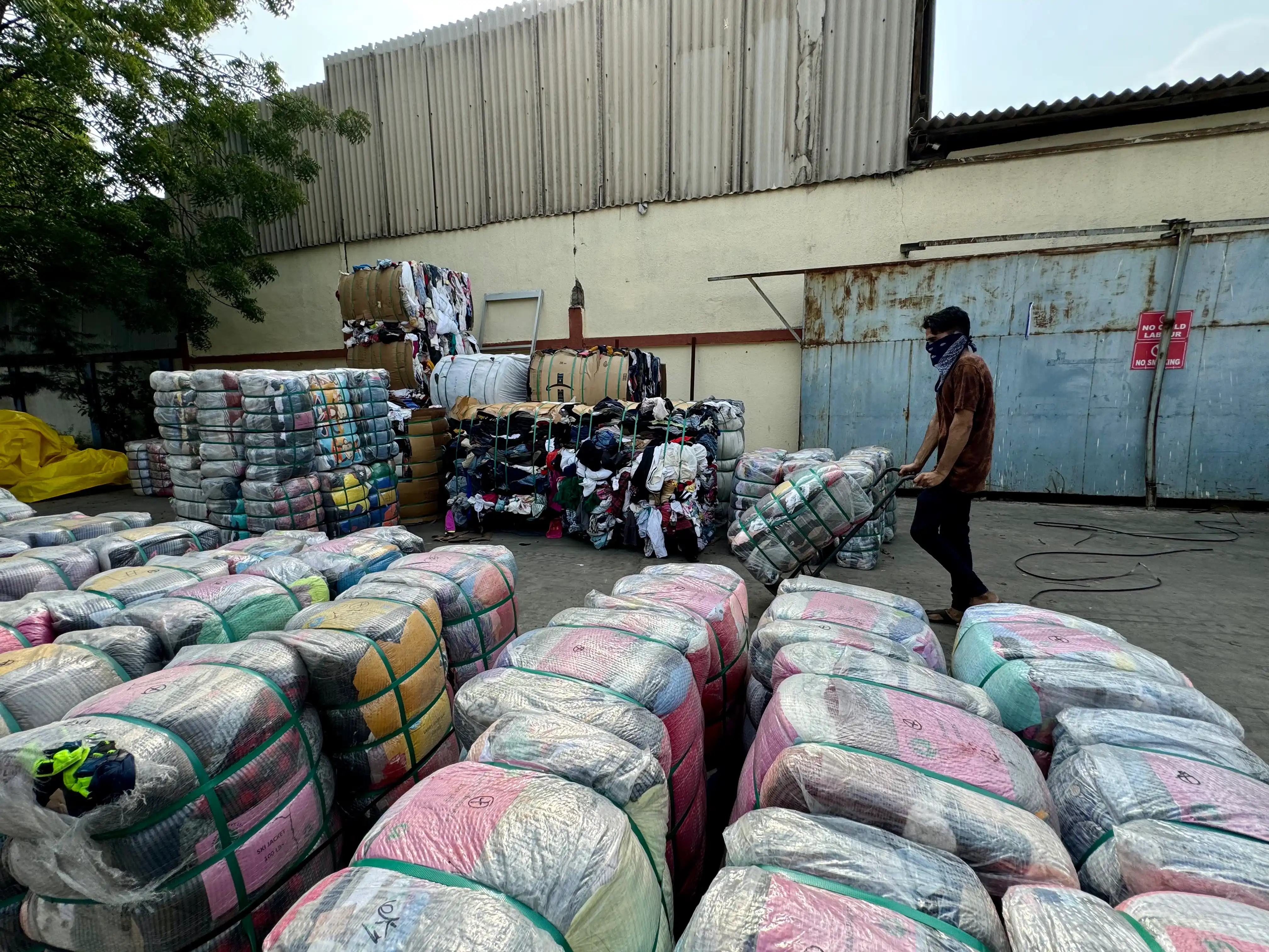 Used clothing bales being final quality checked before shipping